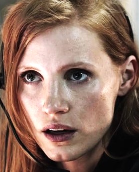 Close-up of a red-haired woman with a worried, slightly open mouth.
